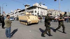 Egyptian Army deploy near the presidential palace to secure the site of overnight clashes between supporters and opponents of President Mohammed Morsi in Cairo, Egypt, Thursday, Dec. 6, 2012. The Egyptian army has deployed tanks outside the presidential palace in Cairo following clashes between supporters and opponents of Mohammed Morsi that left several people dead and hundreds wounded. (AP Photo/Hassan Ammar)