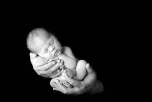 Baby held in fathers hand