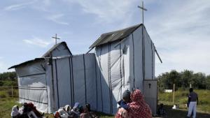 Christian migrants from Eritrea and Ethiopia attend the Sunday mass at the makeshift church in 