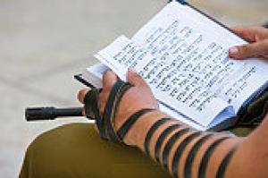 A soldier reads the Torah at the Western Wall.