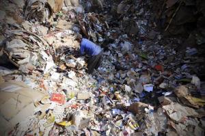 A Coptic Christian man picks up trash before it is recycled inside Garbage City in Cairo. [Cairo’s zabbaleen are primarily Coptic Christians, a sizable minority who have a history of being ostracized by Islamist powers in the country.] For more on Cairo's "Town of Trash," please click on picture.